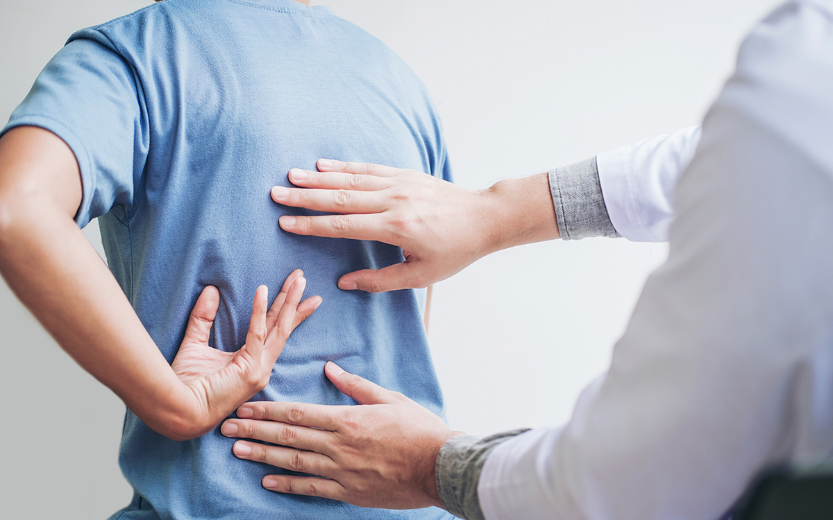 doctor checking patients back