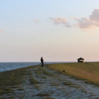person on bike near the ocean